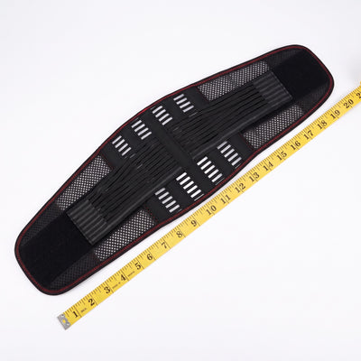 Back belt laid flat next to a measuring tape for scale