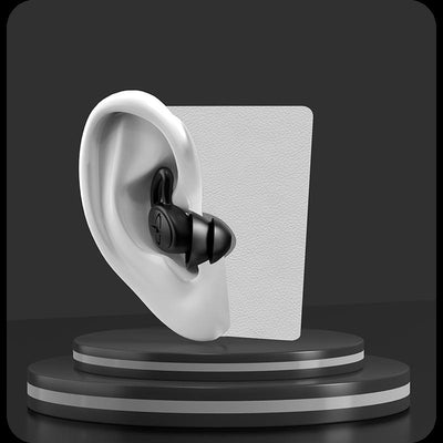 Black silicone ear plug inserted in mannequin ear model