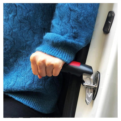 Hand gripping handle hooked into car door latch