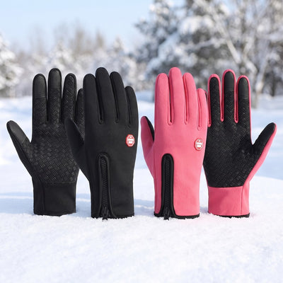 Black and pink winter gloves in snowy outdoor winter scene
