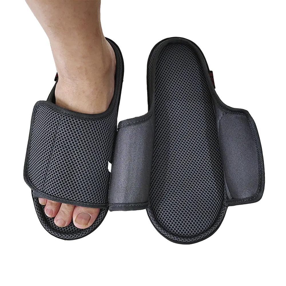 Black mesh slipper worn open on a foot