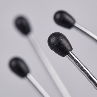 Macro closeup of black bead tips on scalp massager wire tines