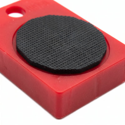 Closeup of red glide pad showing black non-slip rubber surface