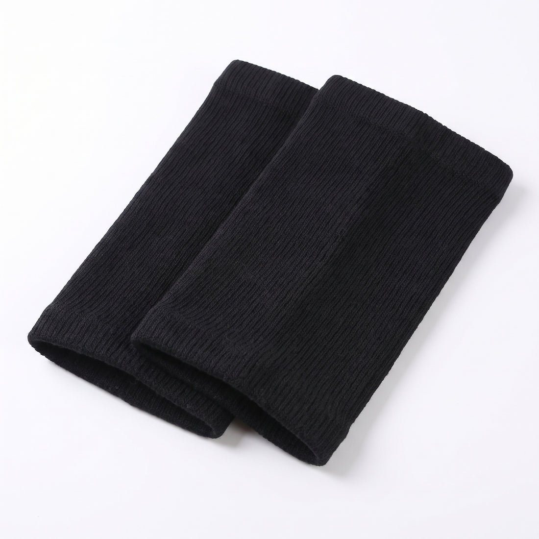 Folded pair of black ribbed knit knee warmer sleeves