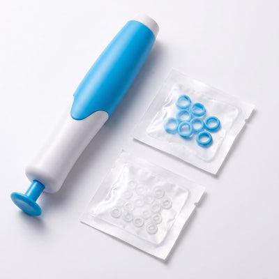 Skin tag removal kit with applicator and rubber band packets on white background