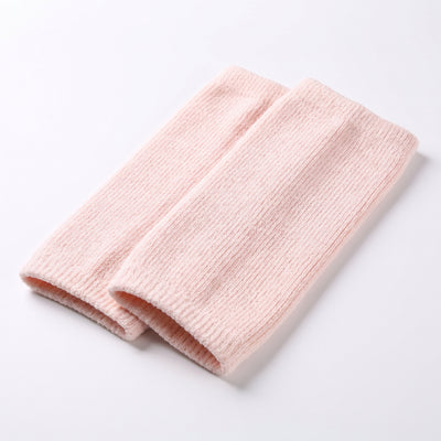 Folded pair of pink ribbed knit knee warmer sleeves