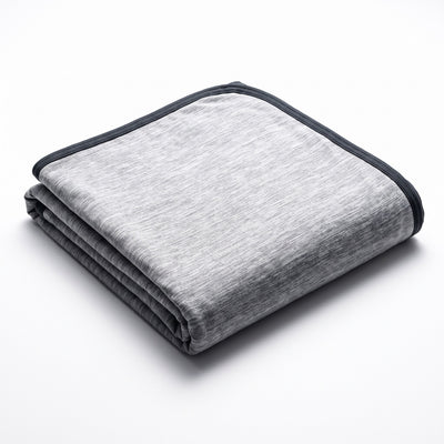 Cooling blanket neatly folded on white background