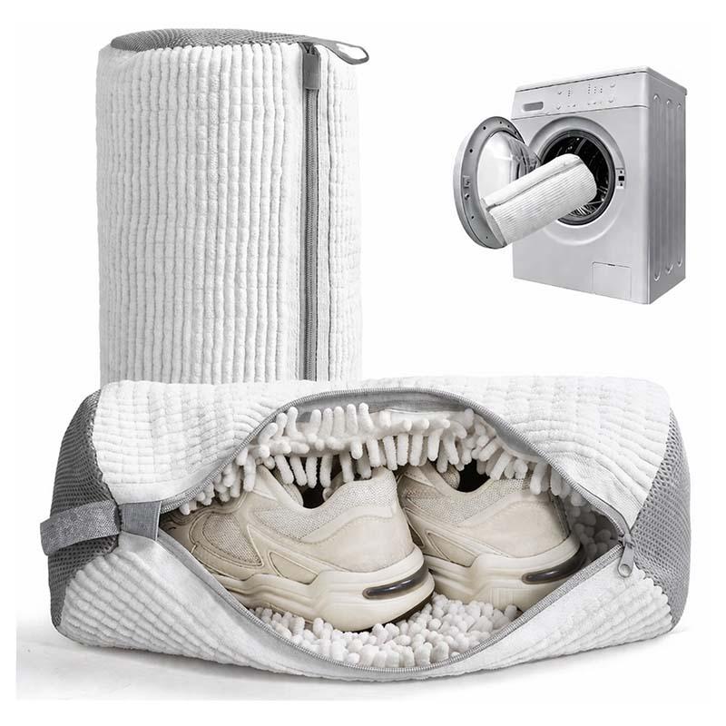 White shoe washing bag open with sneakers inside and washing machine