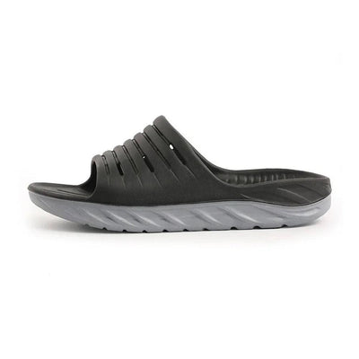 Black cushioned slide slipper side view