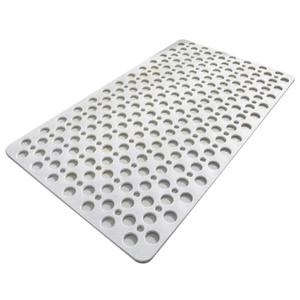 White non-slip bath mat with circular drainage holes on white background
