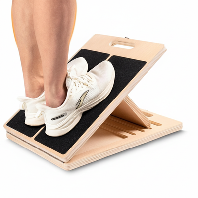 Stretch board in use with athletic shoe on incline surface
