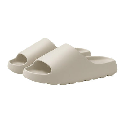 Beige lightweight EVA slide slippers on white background