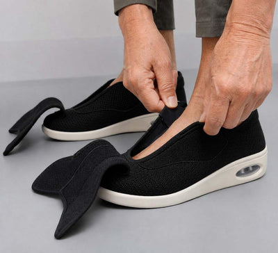 Hands opening velcro strap to show wide adjustable opening