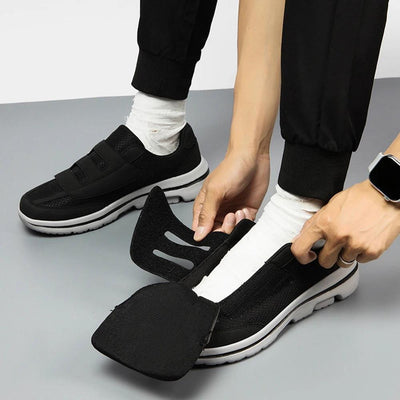 Hands opening velcro strap to put shoe on easily