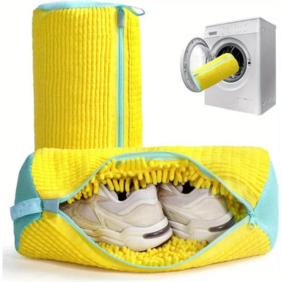 Yellow shoe washing bag open with sneakers beside washing machine
