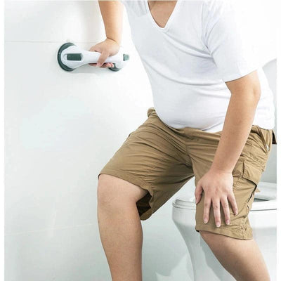 Person using suction cup grab bar in bathroom for support