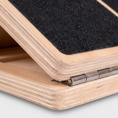 Close-up of plywood edge layers and black non-slip grip tape
