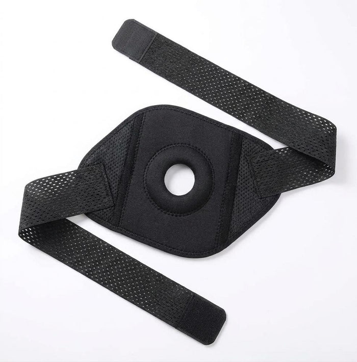 Black open-patella knee brace flat lay on white background