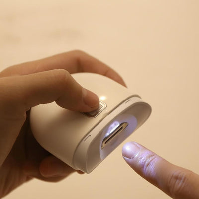 Hand pressing nail clipper LED light button