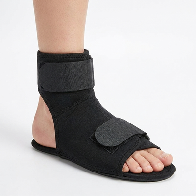 Black night splint sock worn on foot, side view showing ankle and instep straps