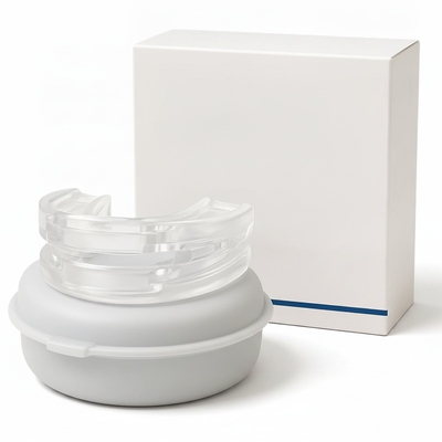 Clear dental night guard with storage case and box on white background