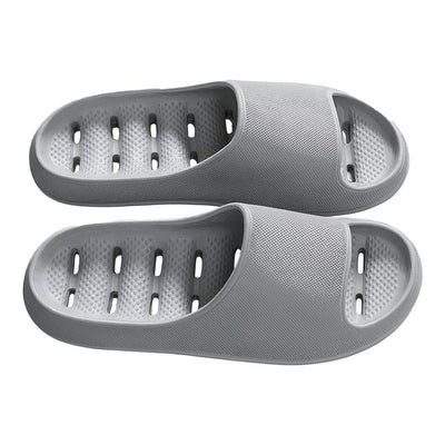 Gray foam bath slides showing perforated drainage footbed