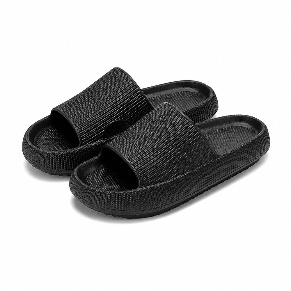 Black platform slide slippers pair on white background