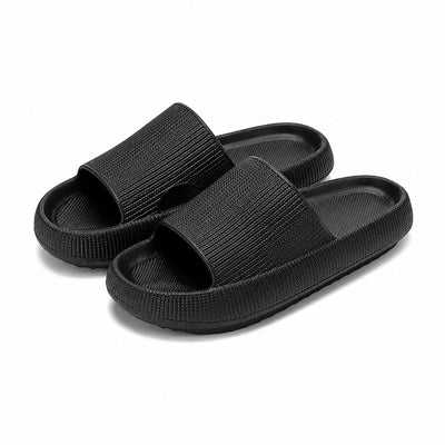 Black platform slide slippers pair on white background