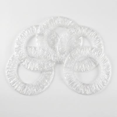 Five clear ear covers arranged in a flat lay